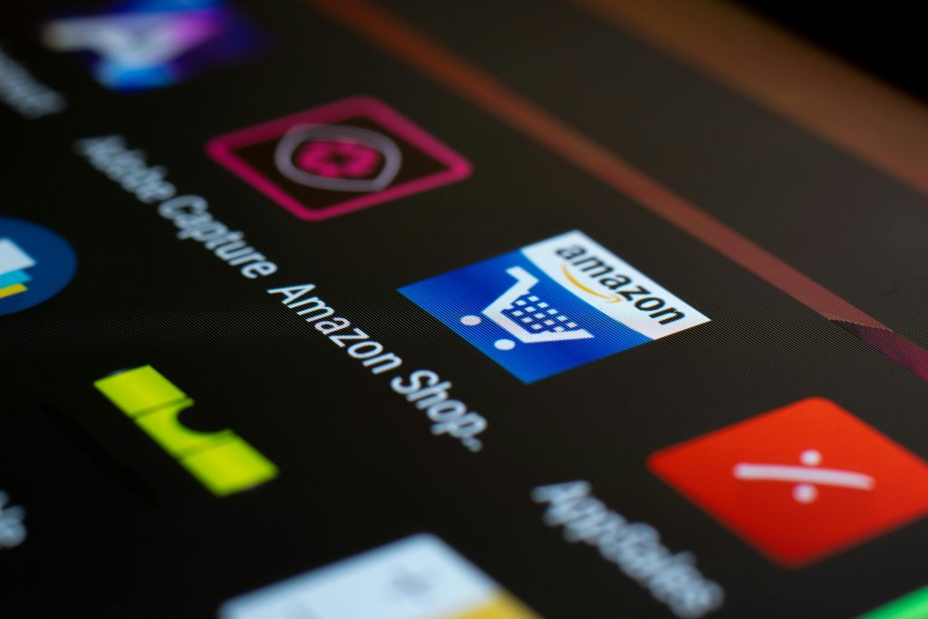 pexels-photo-4560039-4560039 Close-up of the Amazon shopping app icon on a smartphone screen. Ideal for online shopping and technology themes.